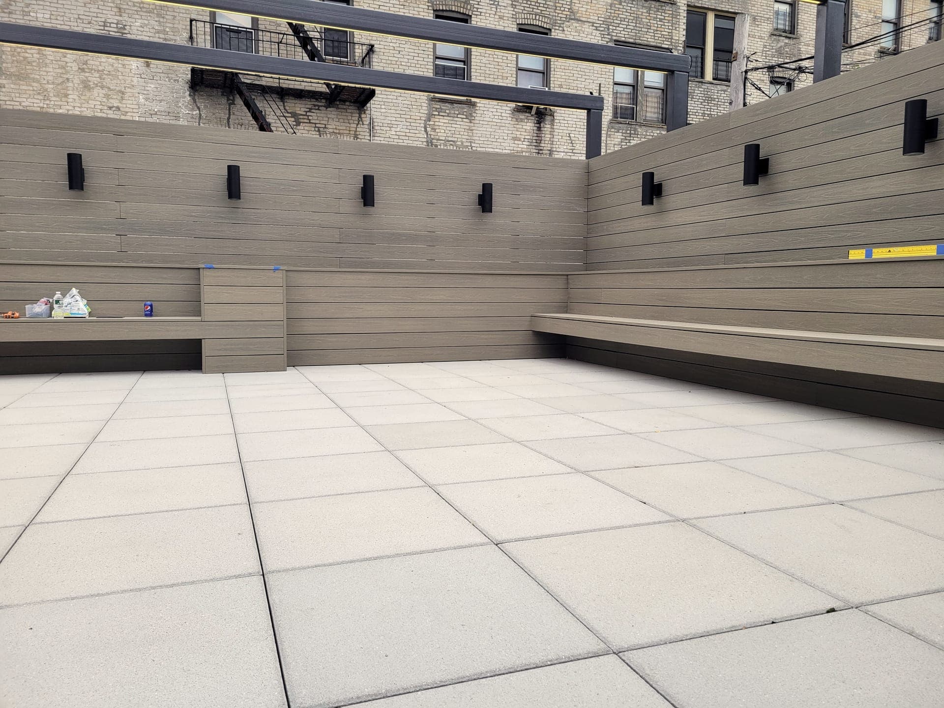 Crown Heights Rooftop — before: Bare terrace, empty planters