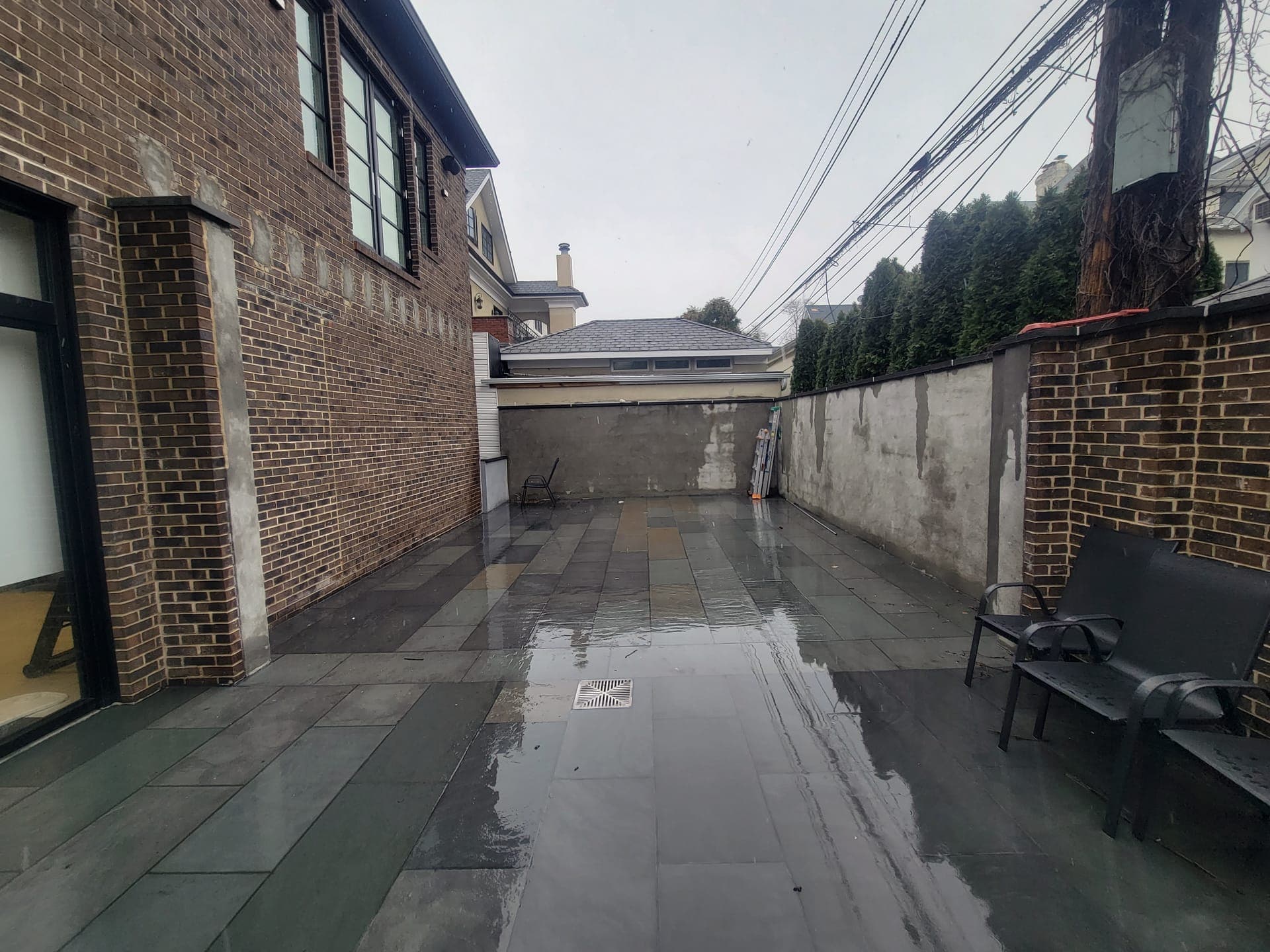 Brick-Walled Backyard — before: Bare yard, raw concrete walls