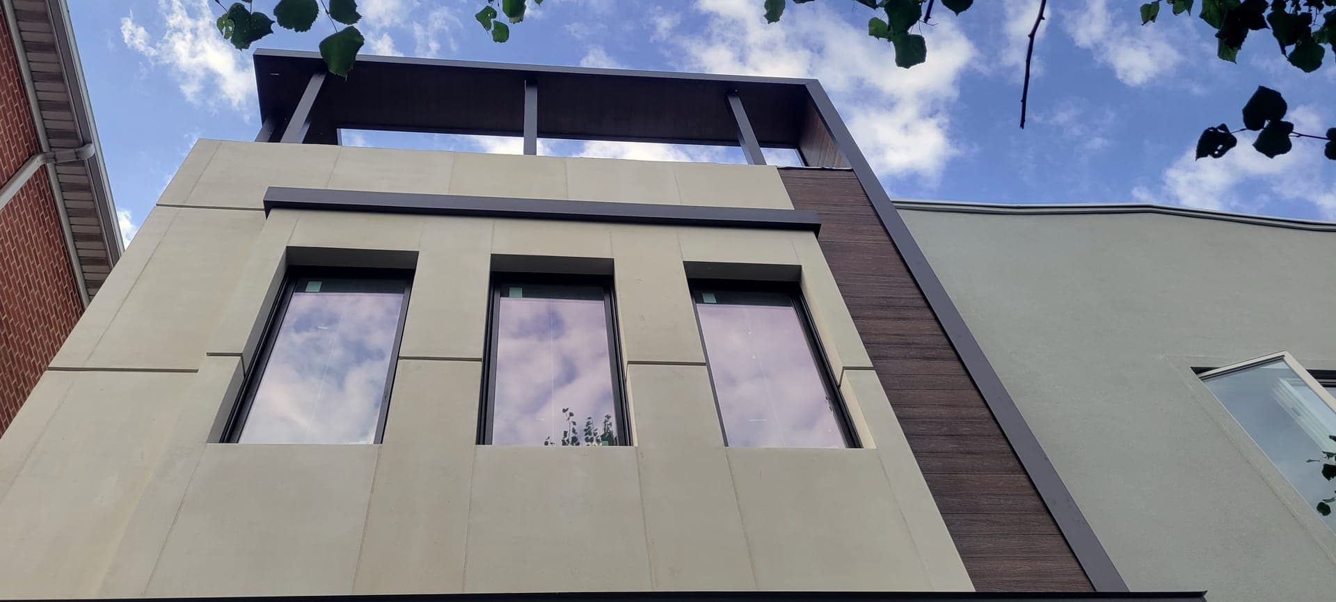East 59th Facade & Pergola — after: Finished porcelain facade, wood accent