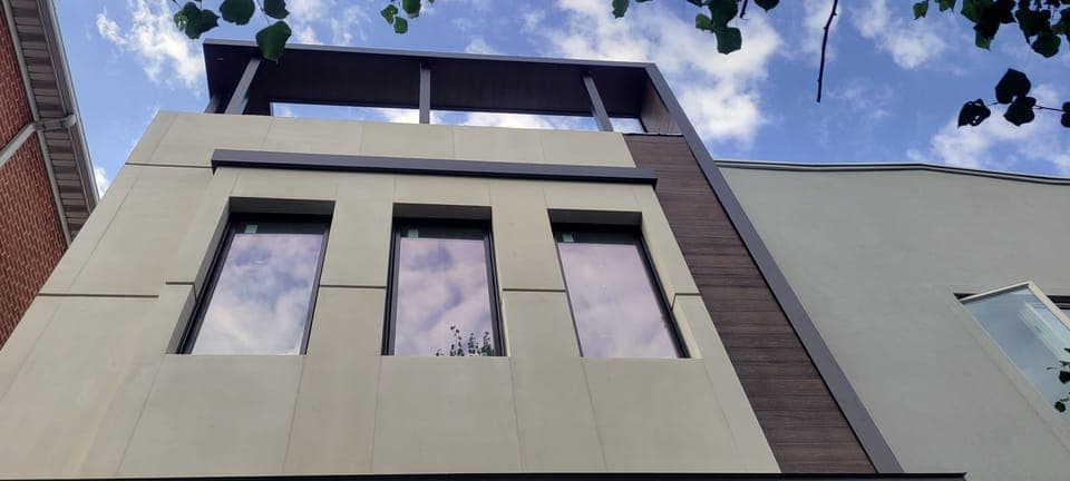 East 59th Facade & Pergola — Finished porcelain facade, dark trim
