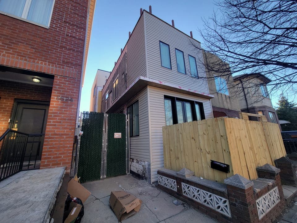 East 59th Facade & Pergola — Facade mid-construction, raw siding
