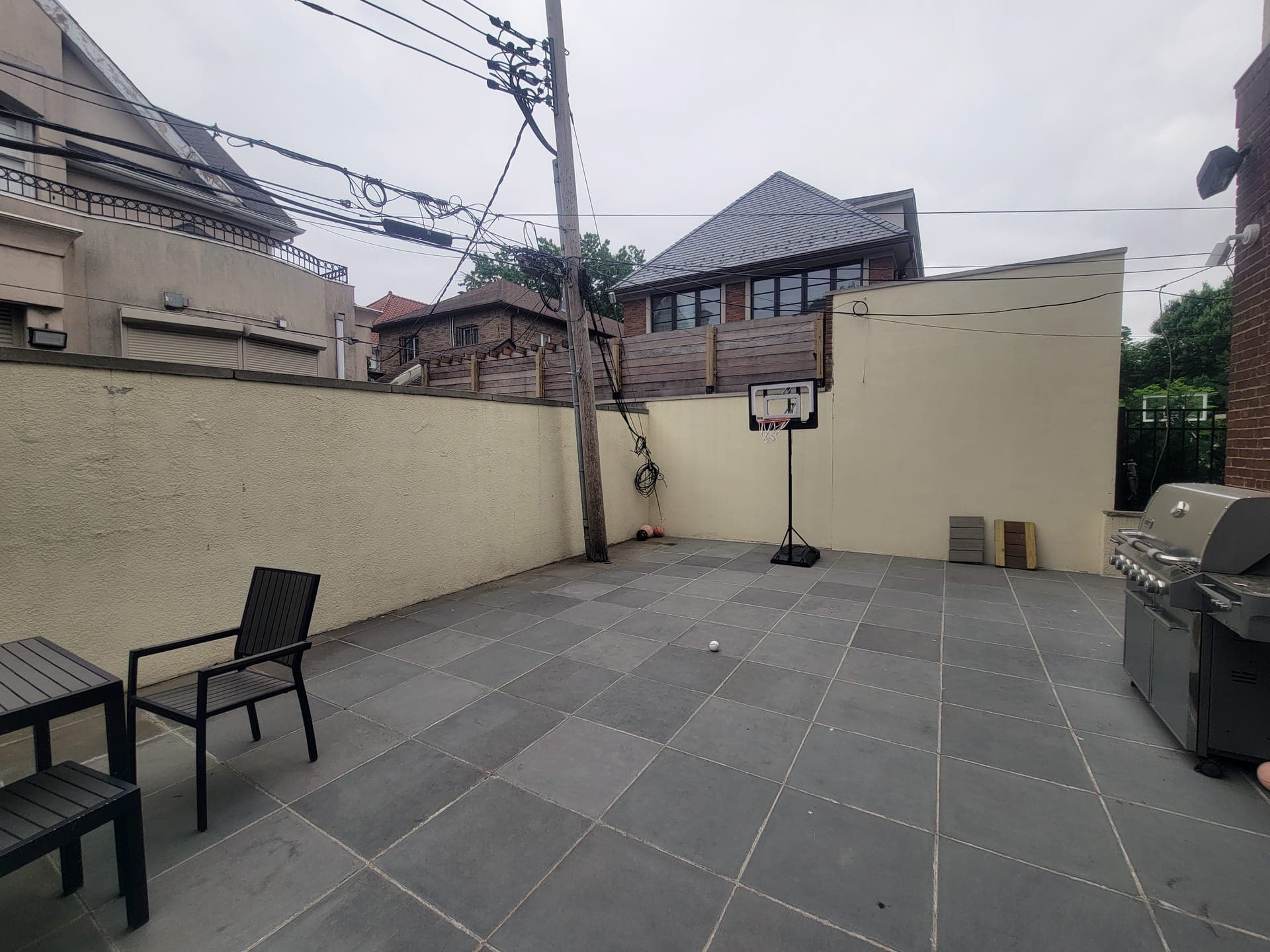 Pergola Patio & Kitchen — before: Empty stucco-walled patio