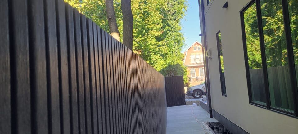 Dark Slat Privacy Screen — Slat fence along walkway