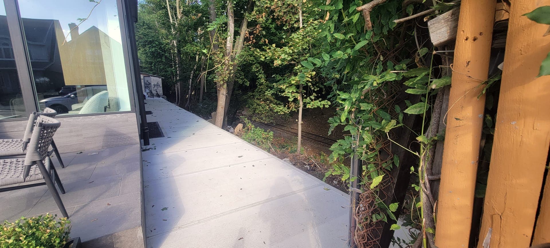Dark Slat Privacy Screen — before: Bare walkway, wooded edge
