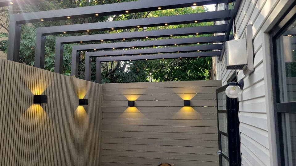 Selected Work — Lit pergola and fence at dusk