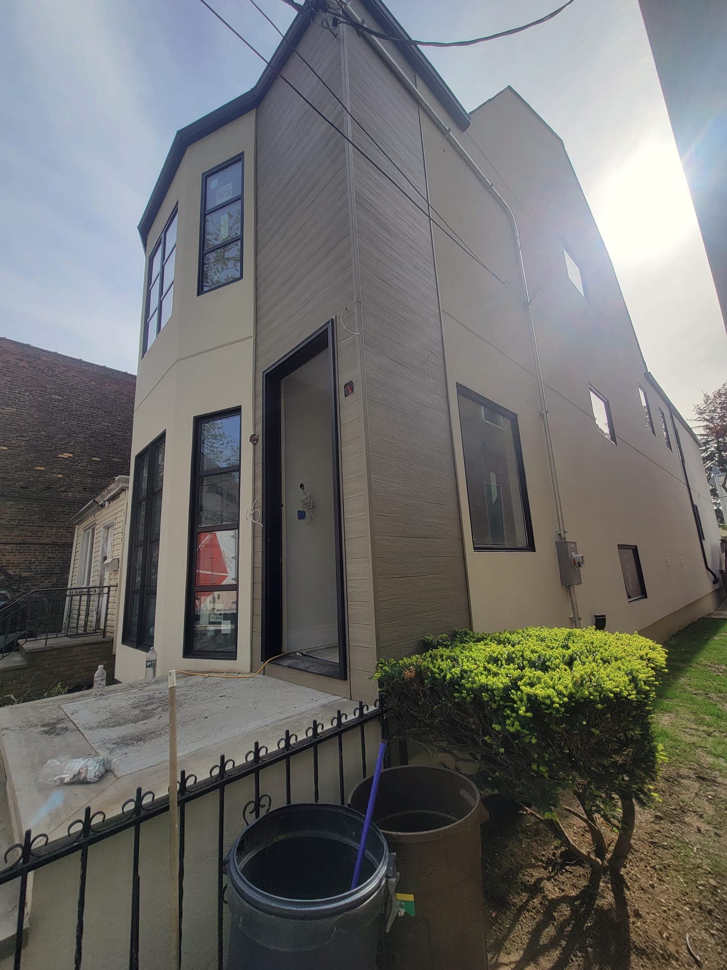 Wood-Clad Facade — Wood-slat siding above the bay window